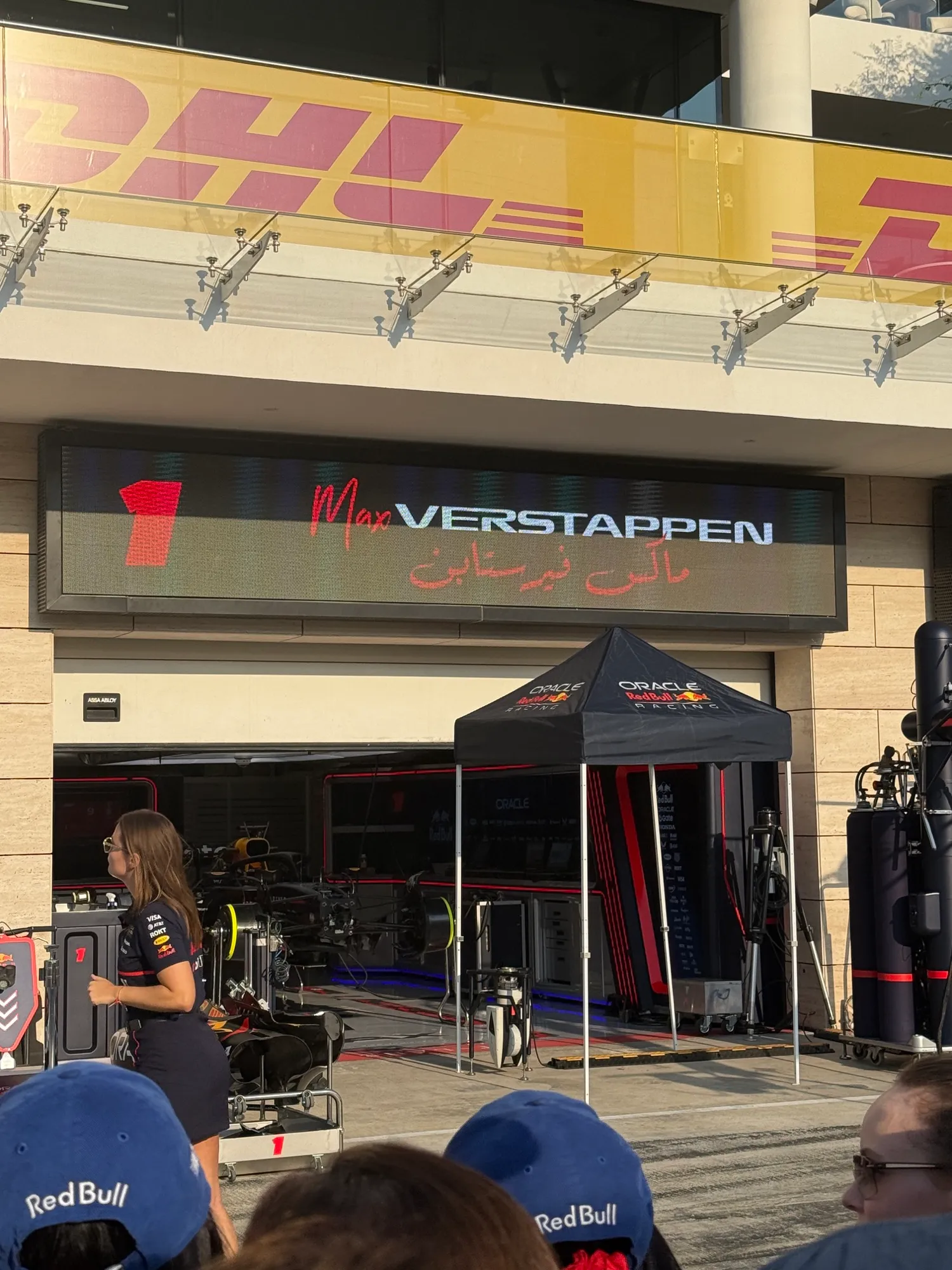 max verstappen’s red bull garage seen over the heads of other guests