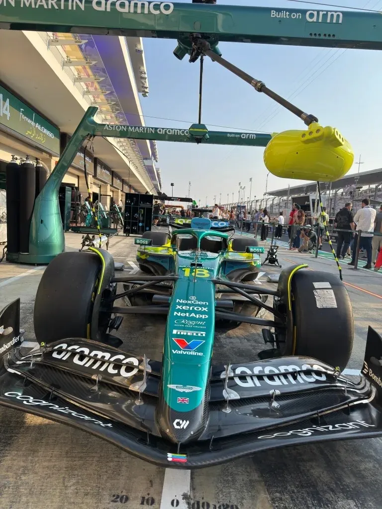 the number 18 aston martin head-on in the pit lane