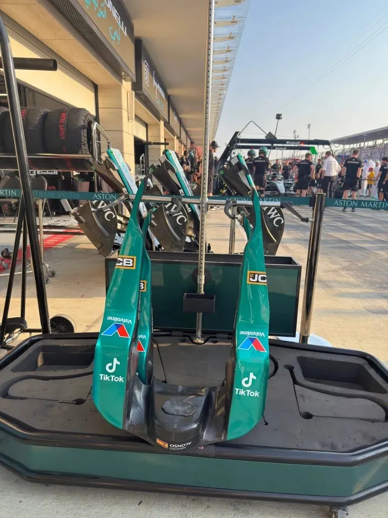 spare aston martin nose cones on a stand in the pit lane