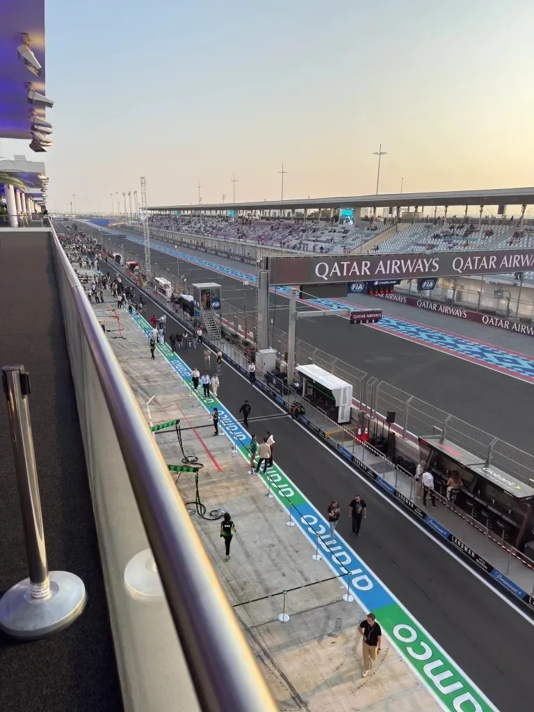 the pit lane and main straight from the paddock club terrace at sunset