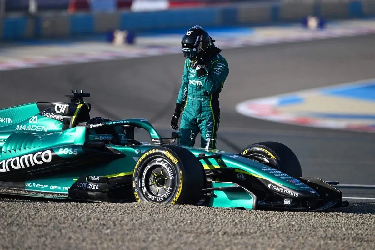 an aston martin driver stands next to his green car, stuck in a gravel trap
