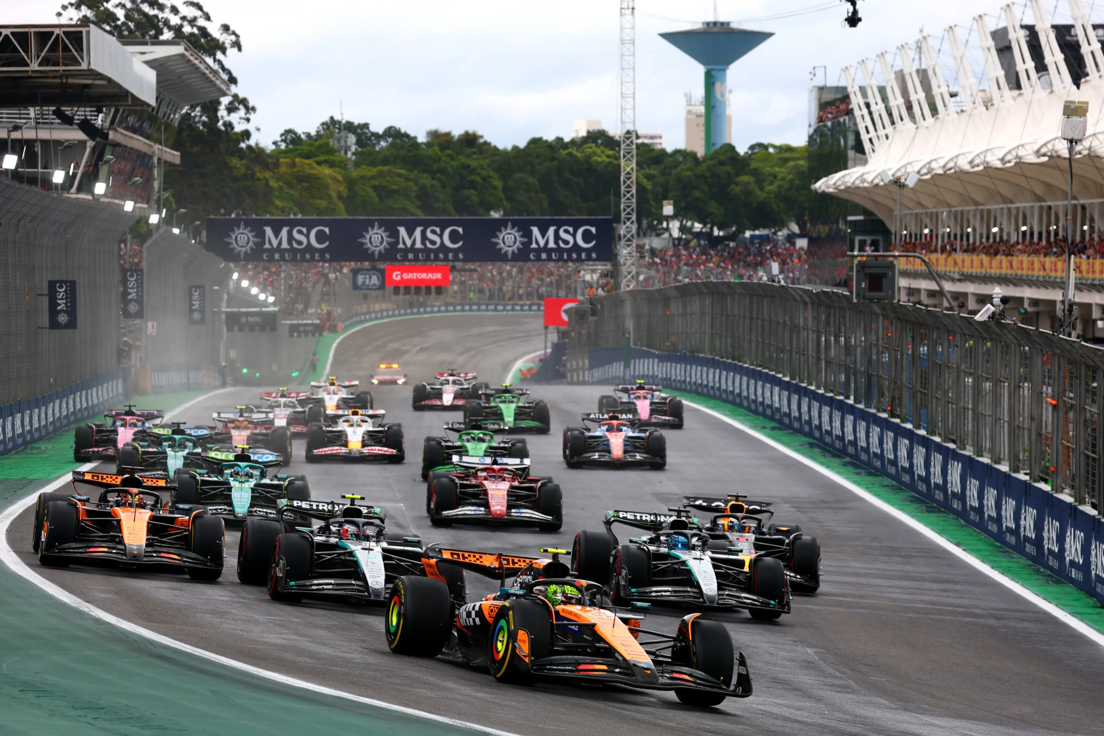 the start at interlagos, a mclaren leading the pack down to the first corner