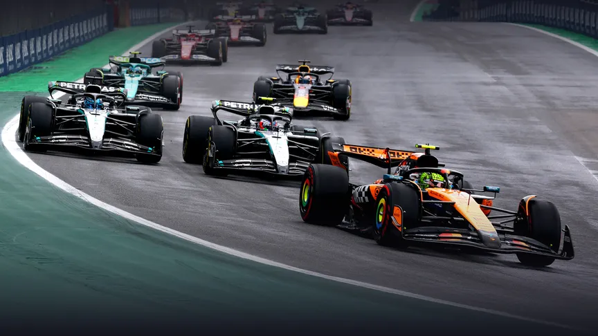 a mclaren leads two mercedes cars through a corner at interlagos