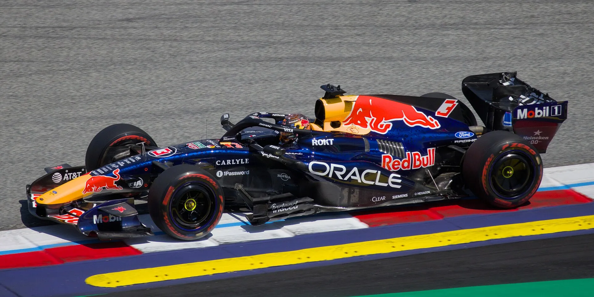 max verstappen's red bull riding the kerb at the red bull ring